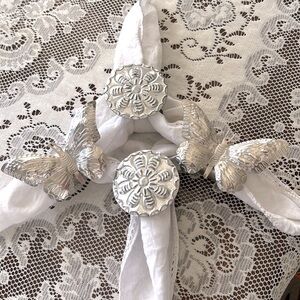 Set of 4 silver toned flowers and butterflies napkin holders.